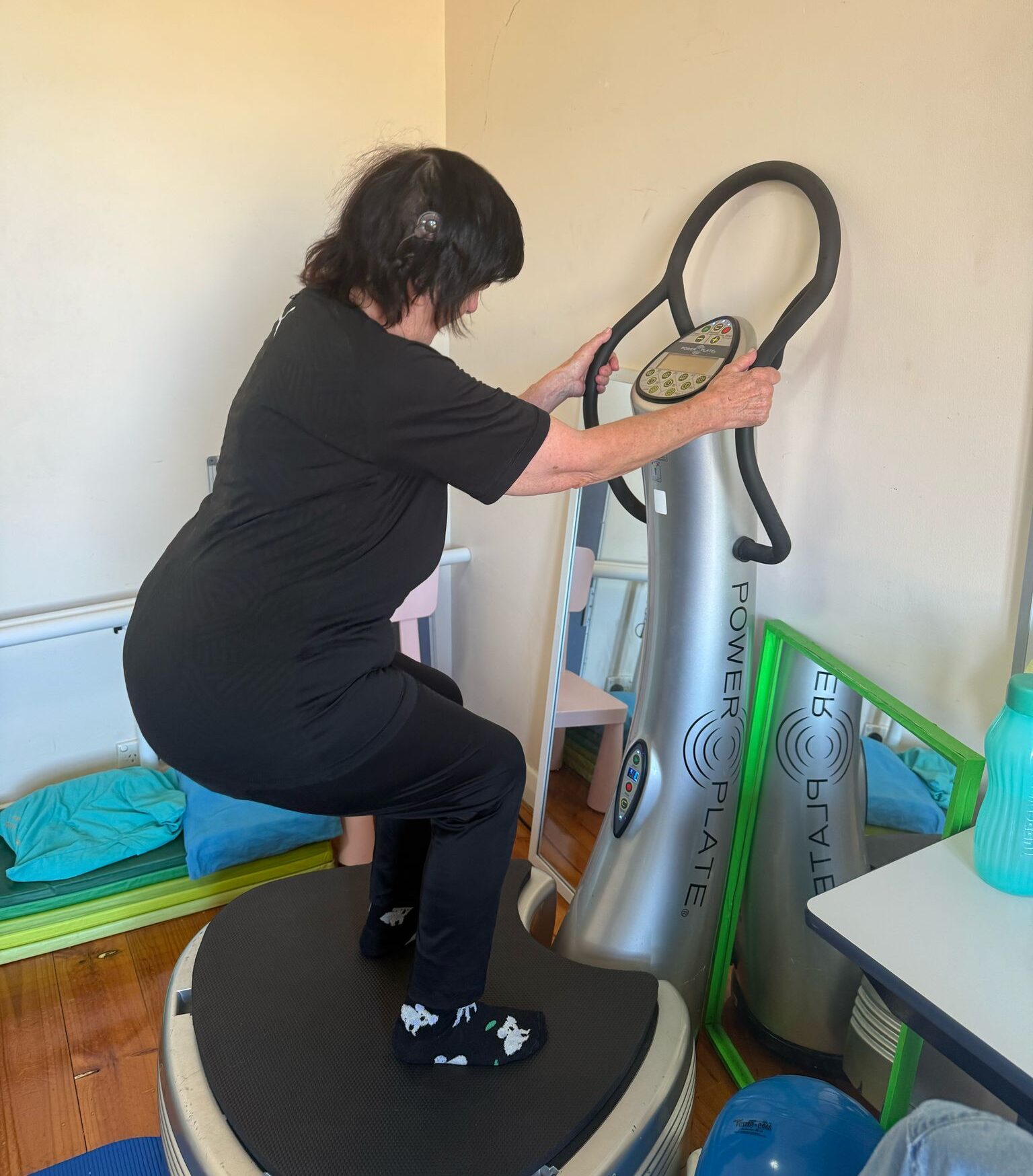an adult doing the power plate vibration therapy