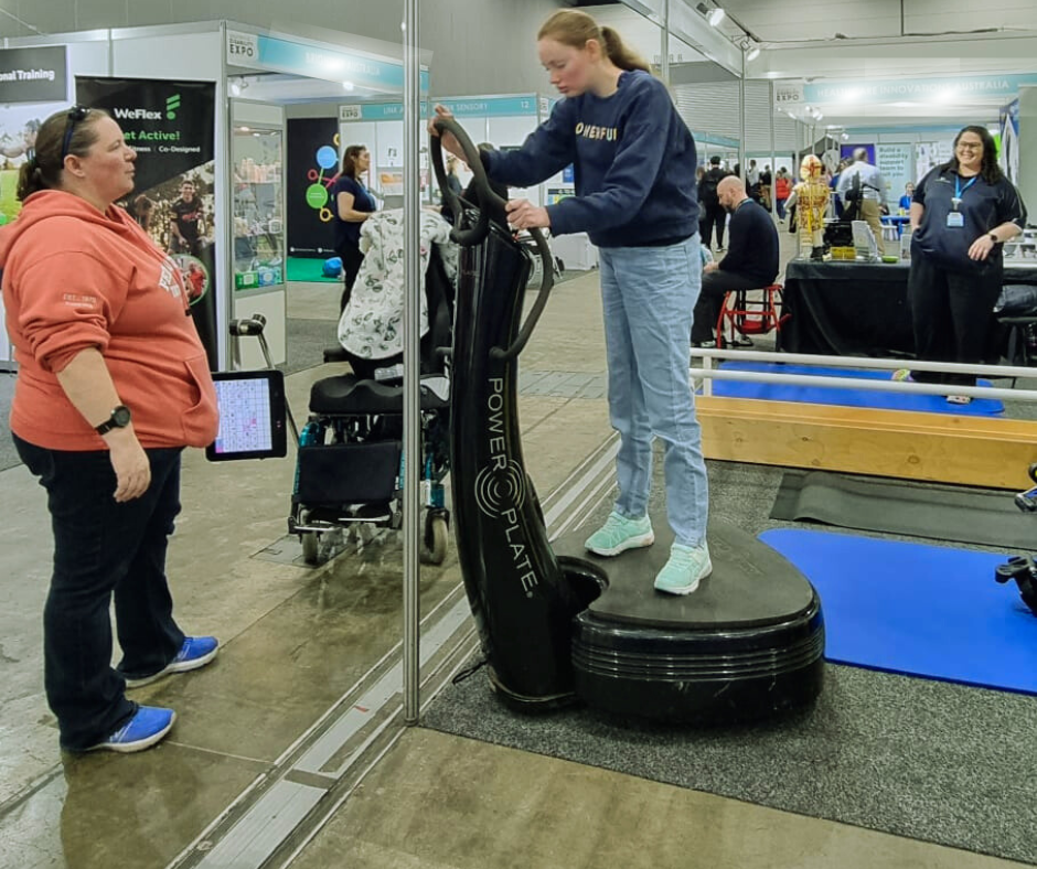 an adult trialing the power plate at the expo
